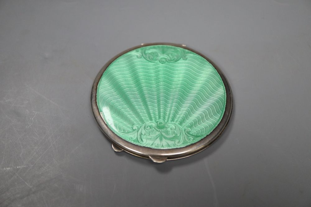 A 1950s silver and green guilloche enamel circular compact, 85mm Birmingham, 1950.